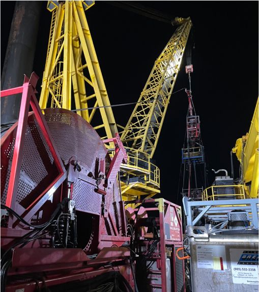 Plug and abandonment equipment on a rig floor at night