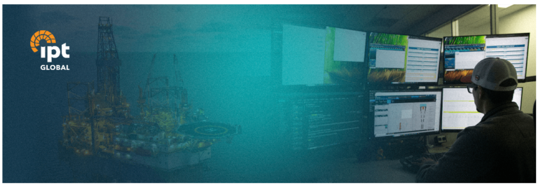 Engineer monitoring real-time well data on multiple screens in an operations center, with an offshore rig in the background